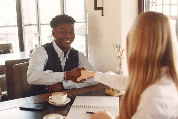 Professional shaking hands with a client at a meeting